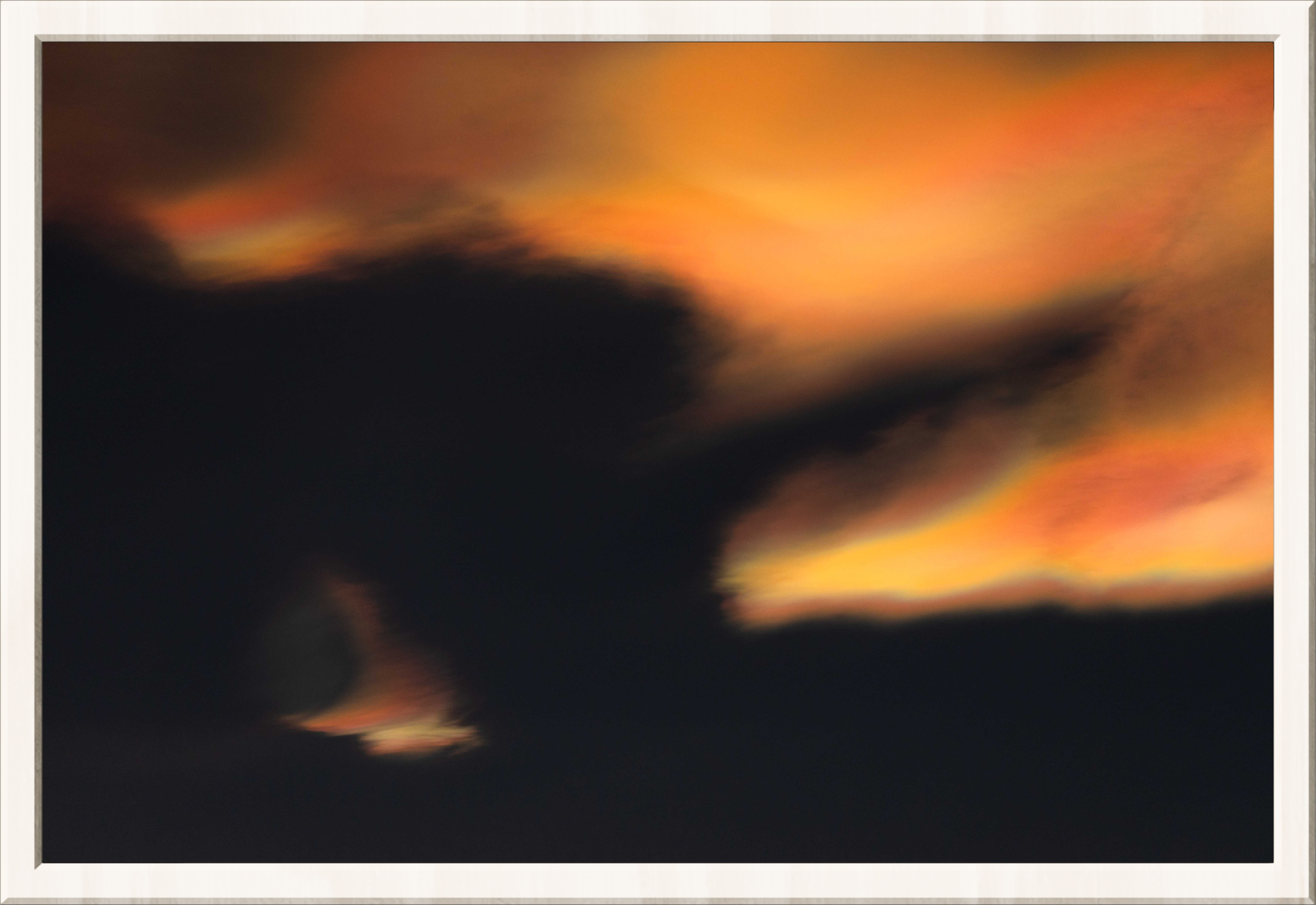 Very orange rainbow clouds in a dark sky