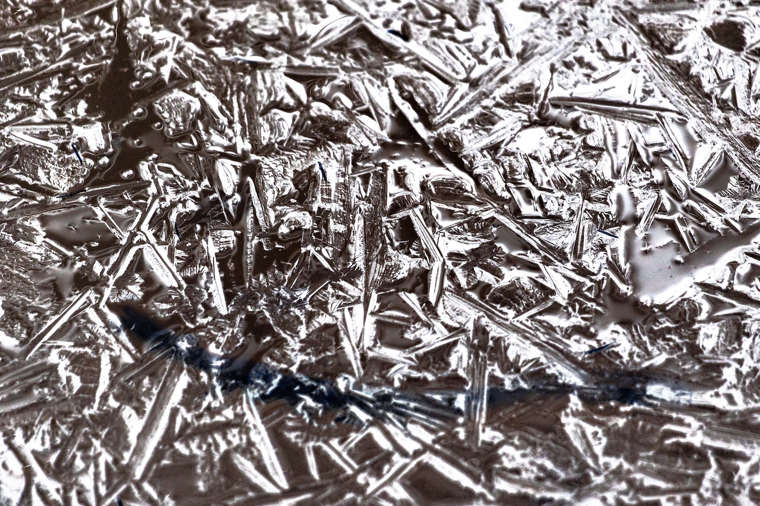 Negative image of crytallized ice framed in a thin white frame